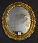 A 19th century oval giltwood and gesso mirror, decorated with acanthus leaves, 2ft .5in. x 1ft