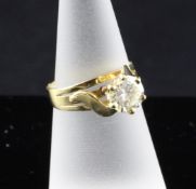 An 18ct gold solitaire diamond ring, the brilliant cut stone weighing approximately 1.3cts, size L