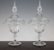 A pair of Victorian glass comports and covers, mid 19th century, with crenelated fold-over rims, the