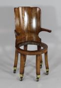 An unusual early 19th century maple chair, with solid curved back above a circular seat on six