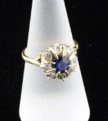 An 18ct gold sapphire and diamond cluster ring, with pierced setting, size N.