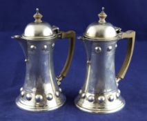 A stylish Edwardian silver bachelor`s cafe au lait pair, of waisted form, with flared bases and