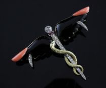 An Art Deco gold, diamond, ruby, black onyx and coral set brooch, modelled as a winged staff,