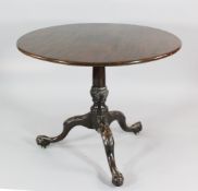 A George III mahogany tilt top occasional table, with turned column, on acanthus leaf carved splayed