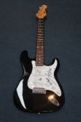 A Swift electric guitar signed by the four members of U2, with certificate of authenticity from