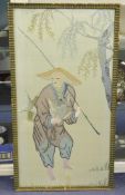 A Chinese embroidered silk picture of a fisherman, late 19th / early 20th century, standing