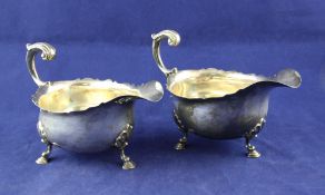 A pair of George V silver sauceboats, with cut rims and scroll handles, on hoof feet, Mappin & Webb,