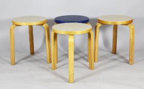 A set of three Alvar Aalto birchwood stools, with cream lacquered seats and a similar blue lacquered