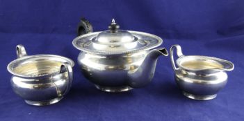 A George V silver three piece tea set, of squat circular form, with gadrooned rim, Mappin & Webb,