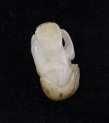 A Chinese white jade carving of a monkey and a baby on it`s back, seated in a scrollwork vessel,