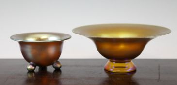 Two WMF Myra iridescent glass bowls, the first on a conical foot, 9in., the second smaller set on