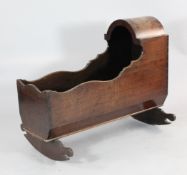 A George III mahogany serpentine cradle, with arched top, 2ft 4in. x 3ft 2in.