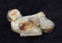 A Chinese grey and brown jade carving, in the form of a stylised bird with a shrew crawling across