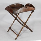 A George III mahogany butler`s tray, with folding sides, on folding stand with turned legs and feet,
