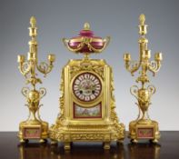 A 19th century French ormolu and porcelain clock garniture, with central urn surmounted clock