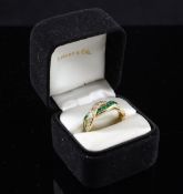 A Tiffany & Co 18ct gold emerald and diamond dress ring, with overlapping rows, in original box,