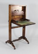 A 19th century Dutch marquetry inlaid walnut portable escritoire, with fall enclosing a fitted