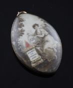 A George III gold and ivory memorial pendant, decorated with a woman beside an urn holding a