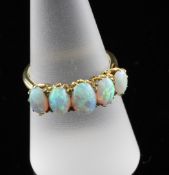 An 18ct gold five stone white opal ring, size P.