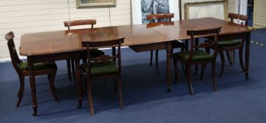 A Regency mahogany extending dining table, with centre section and two D ends on ring turned tapered