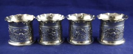 A set of four late Victorian silver candle holders, by William Comyns, of cylindrical form, with