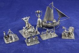Six early 20th century Dutch 833 standard silver miniature groups, modelled as figures at various