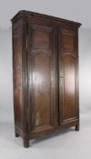 A 19th century French oak armoire, with moulded cornice and panelled doors on stile feet, 7ft 8in. x