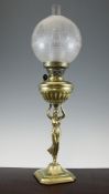 A late Victorian brass figural oil lamp, with frosted glass shade on canted square base, 25in.