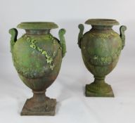 A pair of late Victorian cast iron garden urns, modelled with floral swags on square bases, 2ft 7.