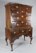 A George II walnut and herringbone inlaid chest on stand, with two short and three graduated long