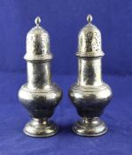 A pair of George V silver baluster sugar casters, the stepped lids with reeded knops, marks