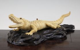 A Japanese ivory figure of a crocodile, early 20th century, with horn and mother of pearl inset eyes