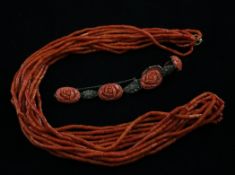 A multi strand coral bead necklace with 9ct gold clasp, 31in, together with a silver carved coral