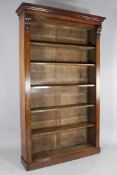 A Victorian carved mahogany open bookcase, with moulded cornice above six adjustable shelves, on