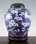 A Chinese blue and white ovoid jar, late 19th century, painted with prunus blossom on a blue ground,