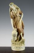 A Royal Dux pottery figure of a female water carrier, in predominantly ivory and brown colours, gilt