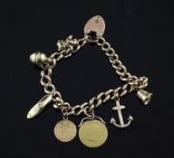A 15ct gold curb link charm bracelet, with 9ct gold padlock clasp and seven mainly 9ct gold