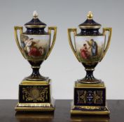 Two Vienna style porcelain style vases and covers, c.1900, each painted with scenes depicting