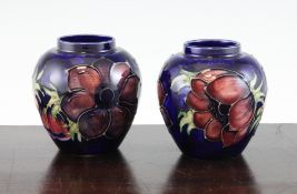 A pair of Moorcroft `Anemone` pattern small ovoid jars, post-war, with cobalt blue ground, impressed