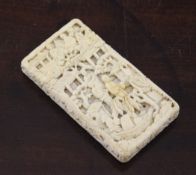 A 19th century Chinese export carved ivory card case, carved in relief with figures and pavilions,