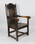 A 17th century oak chair, with panelled back on square legs