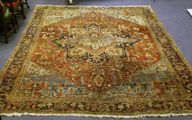 A Large Turkish carpet, with central foliate medallion, within a stylised star motif, on a red and