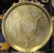 A Persian silver and copper overlaid brass tray, decorated with script and foliate roundels, 25in.