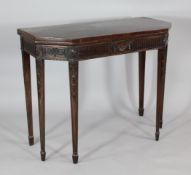 A George III mahogany card table, on husk carved square tapering legs, 1ft 4.5in. x 3ft