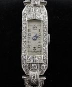 A lady`s 1930`s platinum and diamond set cocktail watch, with rectangular Arabic dial inscribed "