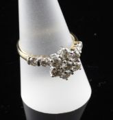 A 9ct gold diamond cluster ring, of flowerhead design, with diamond set shoulders, size S.