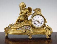 A 19th century French ormolu mantel clock, surmounted with Cupid holding a rose, with enamelled dial