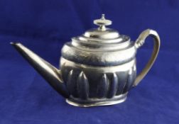 A George III silver oval teapot, with lobed body and engraved initials with armorial, Soloman