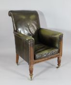A William IV carved mahogany library chair, with green leather upholstery on turned and fluted