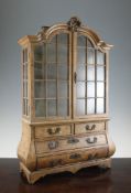 A late 19th century Dutch walnut miniature bombe display cabinet, on bracket feet, 27in.